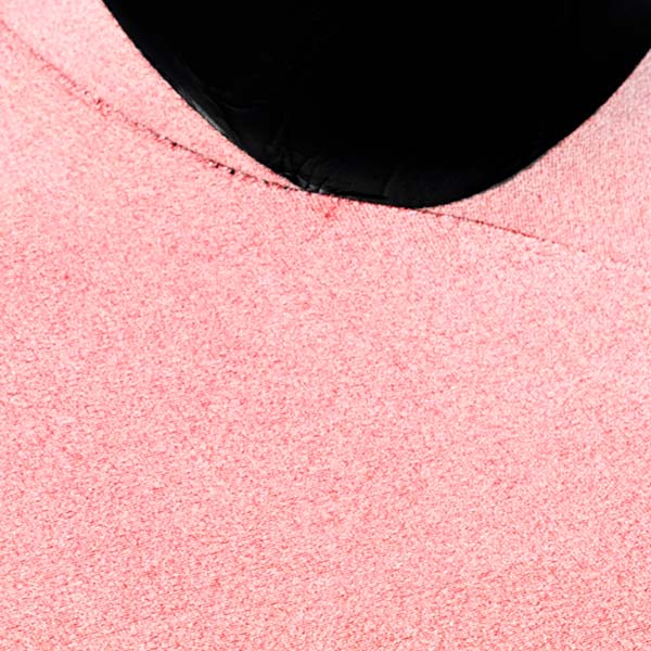 Close-up of pink fabric with a black circular object on top