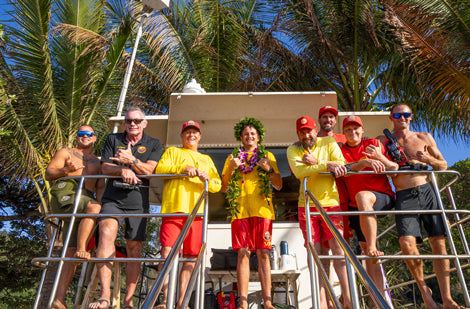 Group of people on a boat with palm trees in the background