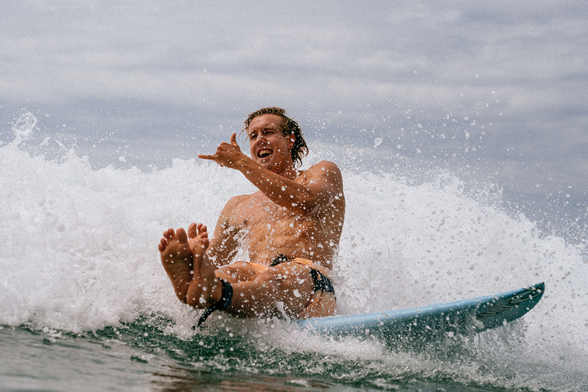 A man having fun on his surfboard