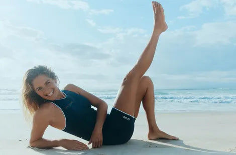 Steph Gilmore's striking a model-like pose on the beach