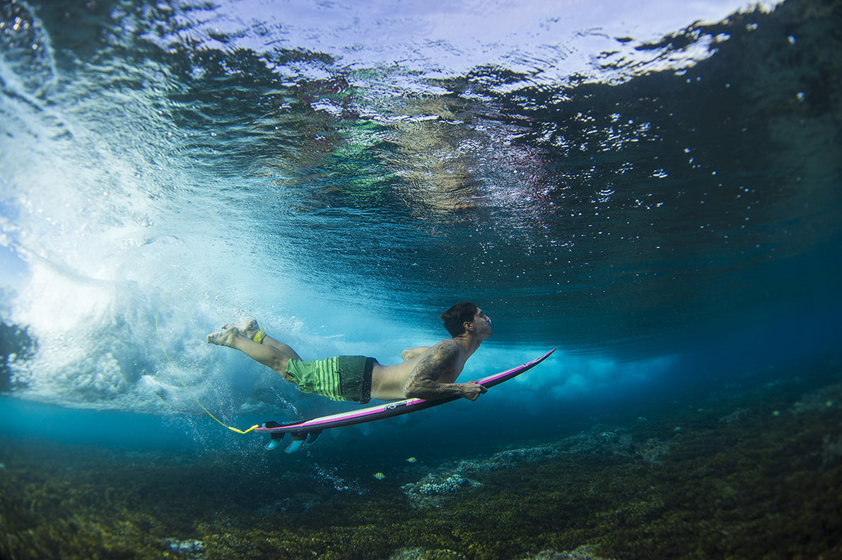A surfer under water with surfboard