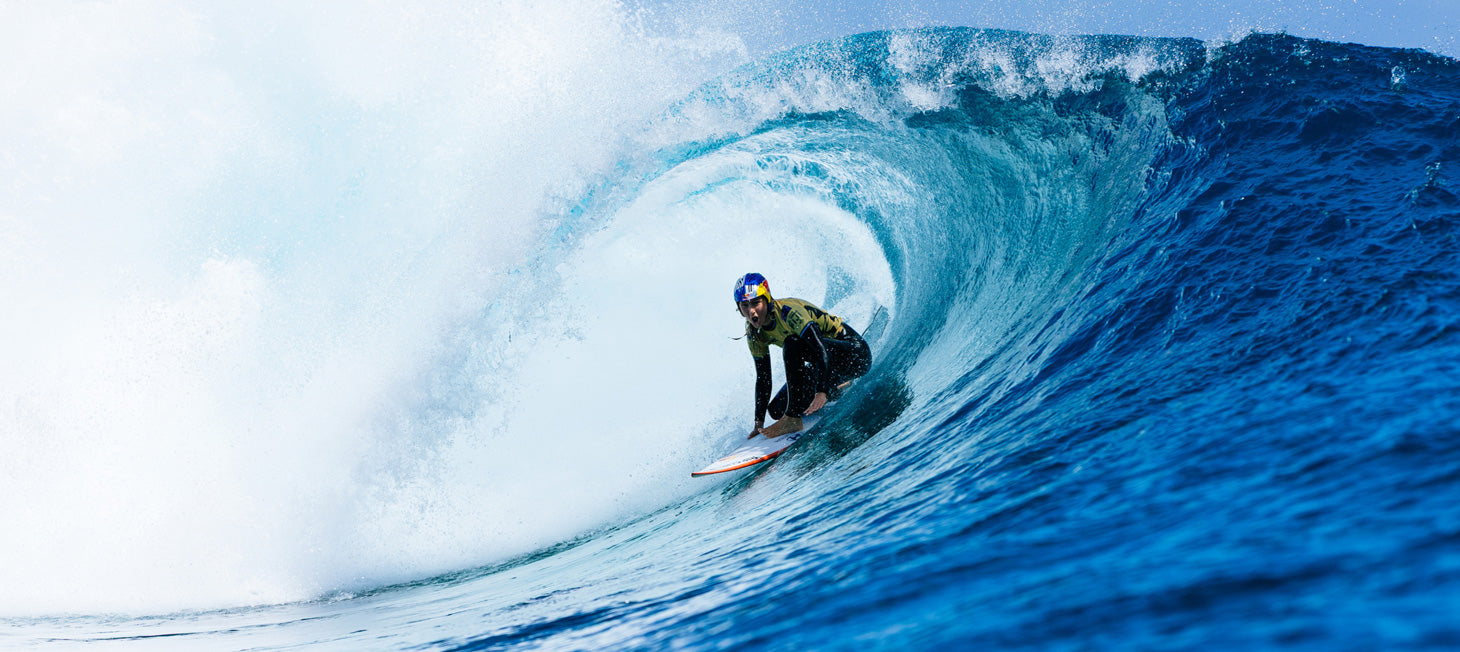 Surfer riding a large wave in the ocean