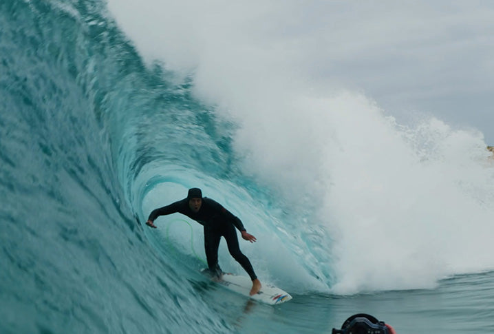 Person surfing a large wave in the ocean