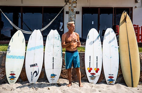 Surfer and different surfboards
